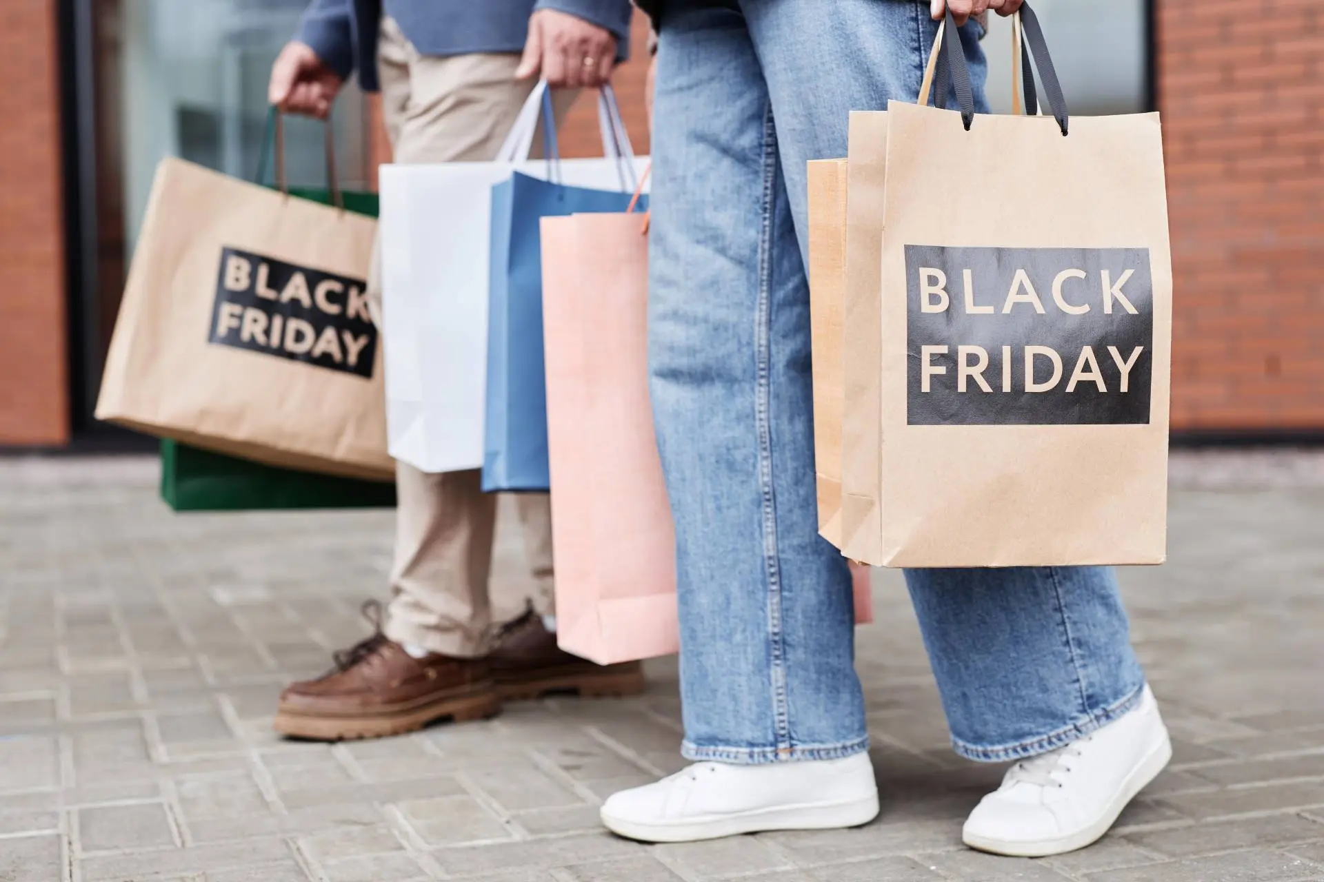 customers carrying bags after purchasing items from black friday sale of a small business